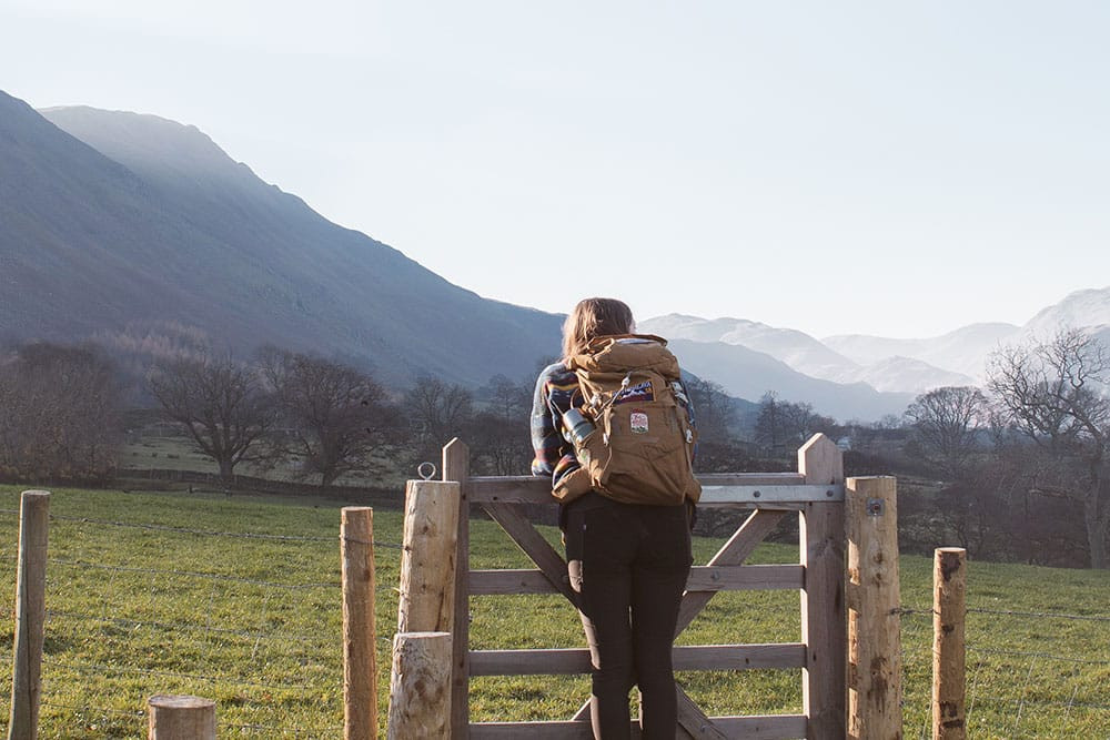 image of a woman with a backpack facing the view