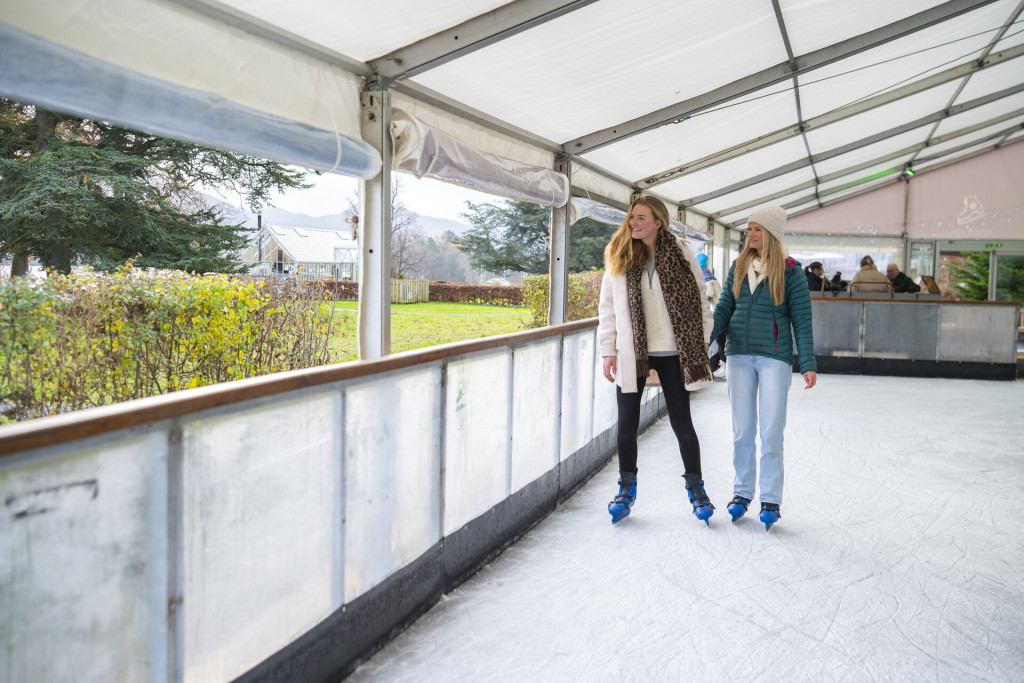 Skaters on the rink overlooking the lake