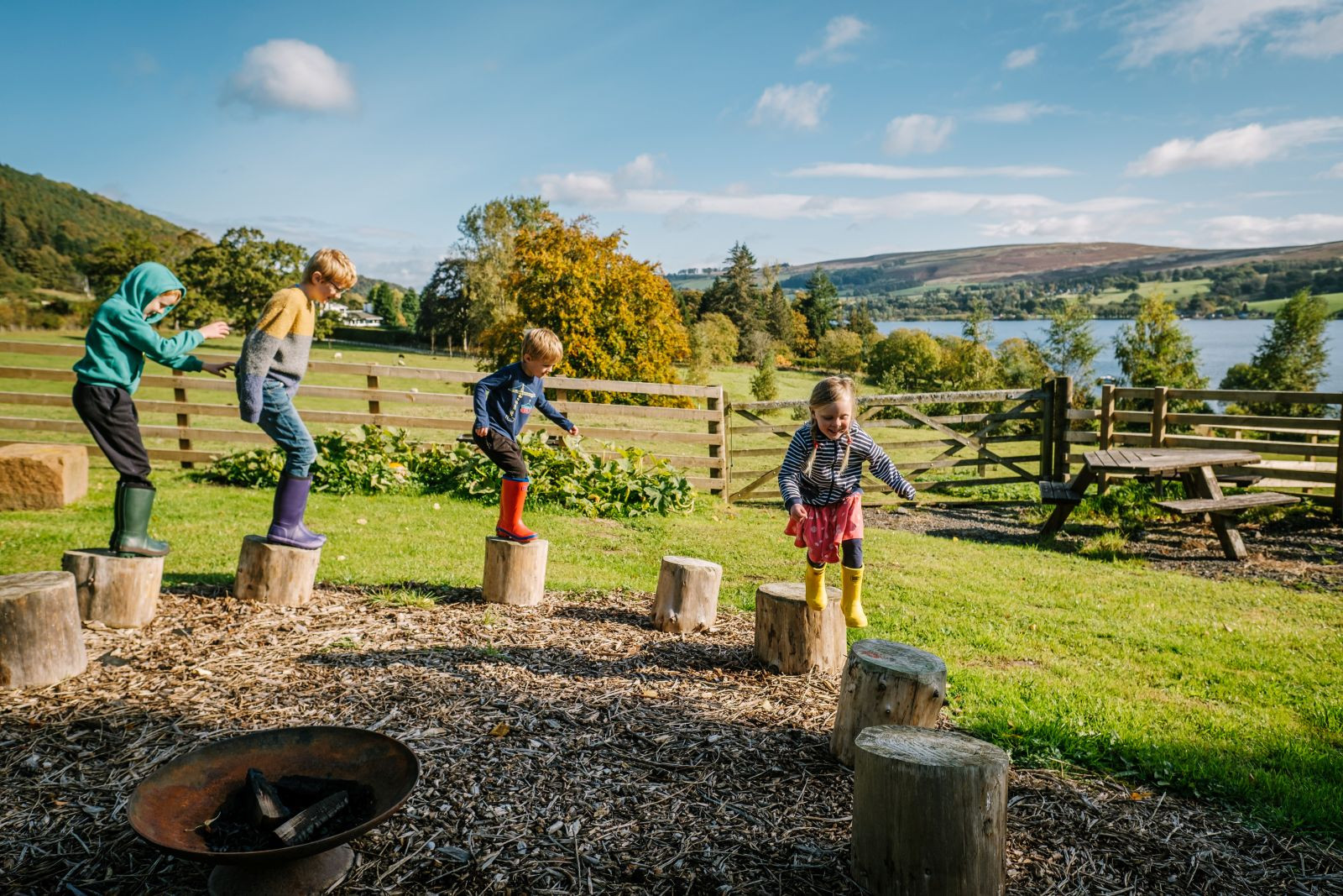 Kids playing on log stumps