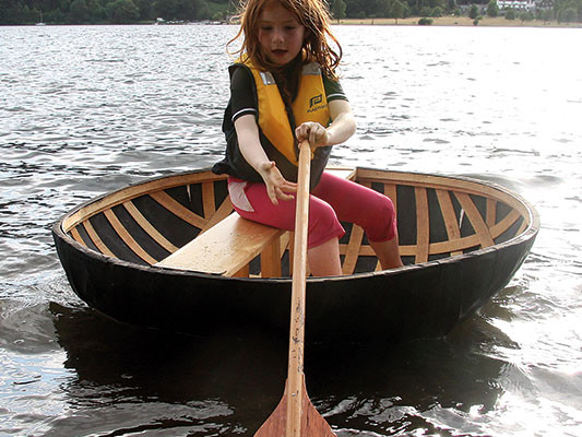 Kevins daughter Maddy tests the coracle near side farm ullswater July 