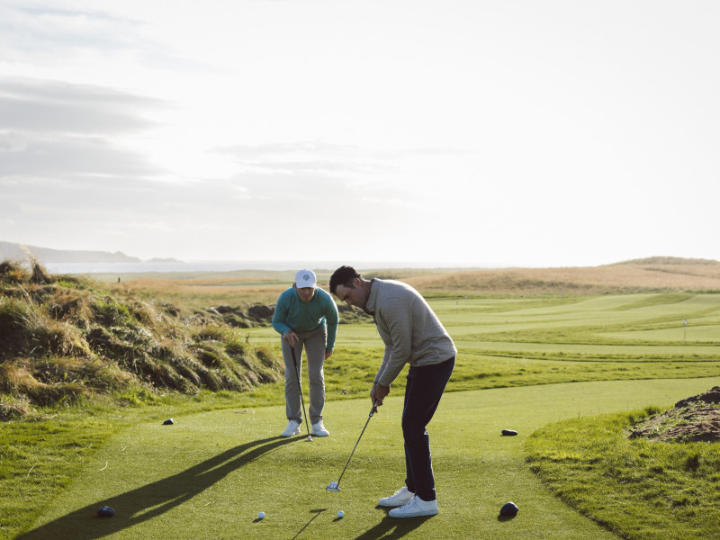 Two men playing social golf at Another Place The Machrie