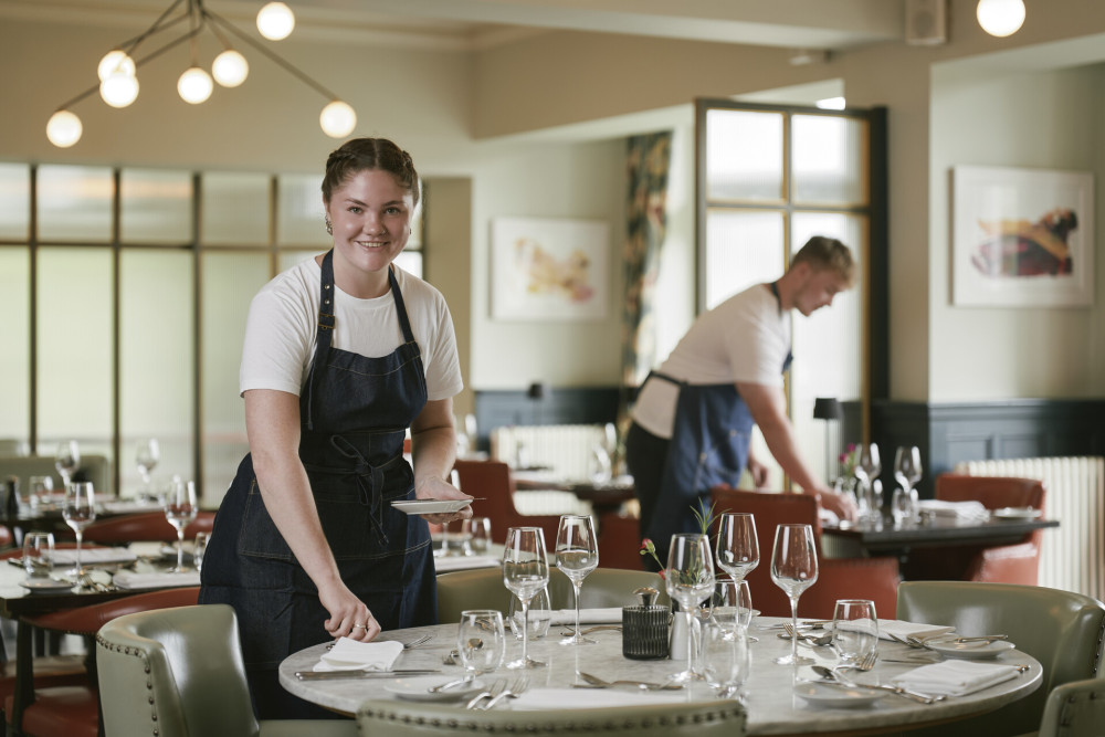 Waitress laying tables in Rampsbeck
