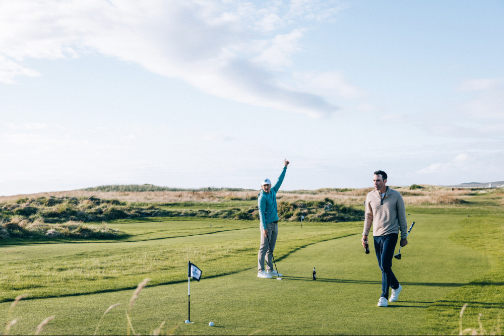 Two men playing the hebrides social golf course at Another Place, The Machrie