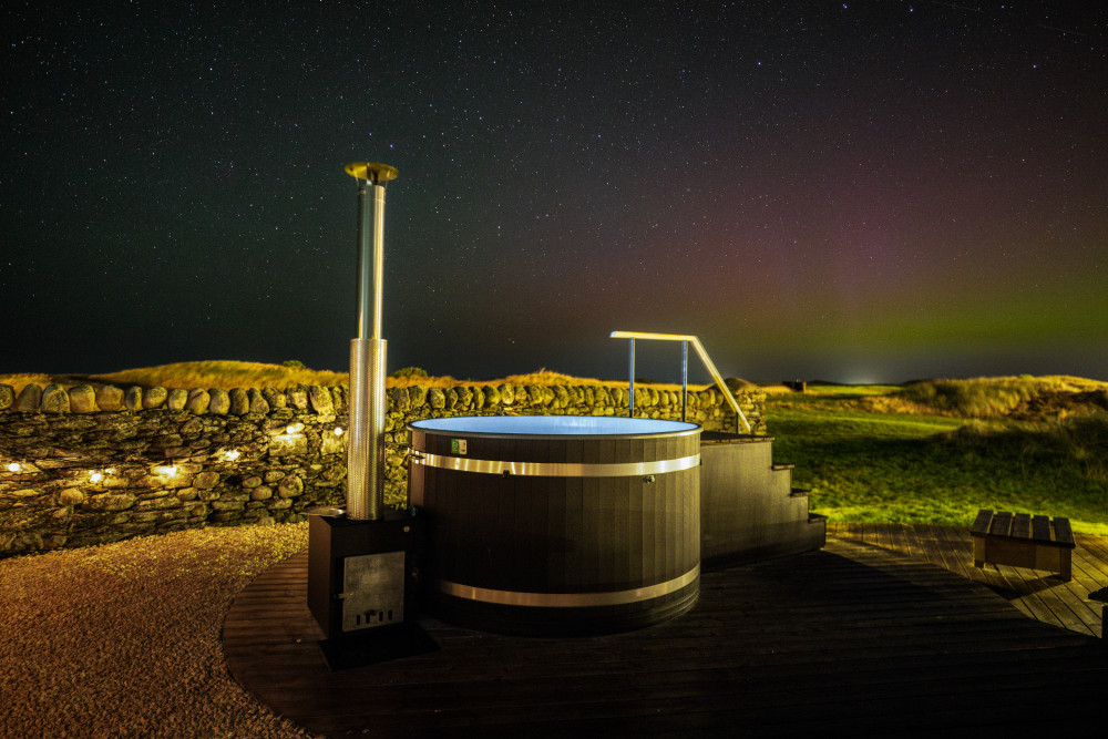 Hot tub in the wild garden at Another Place The Machrie, overlooking the northern lights