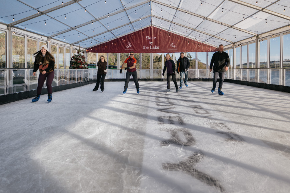 People skating on ice rink by the Lake