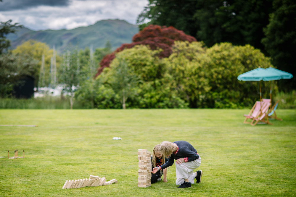 Woman and child playing giant jenga on the lawn