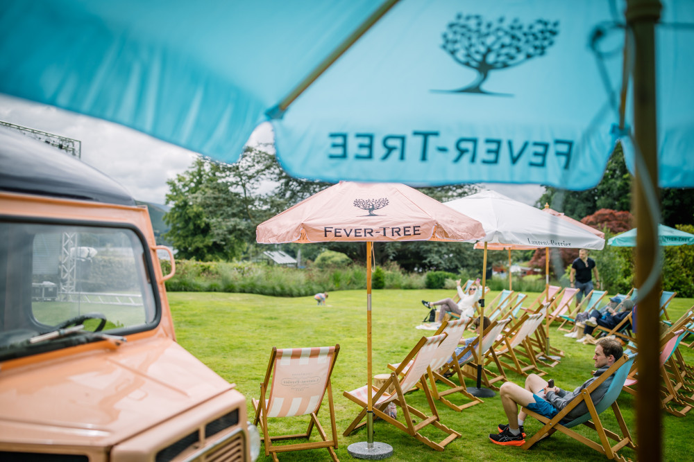 People sat under the fever-tree parasols at Another Place, The Lake during Game, Set, Match