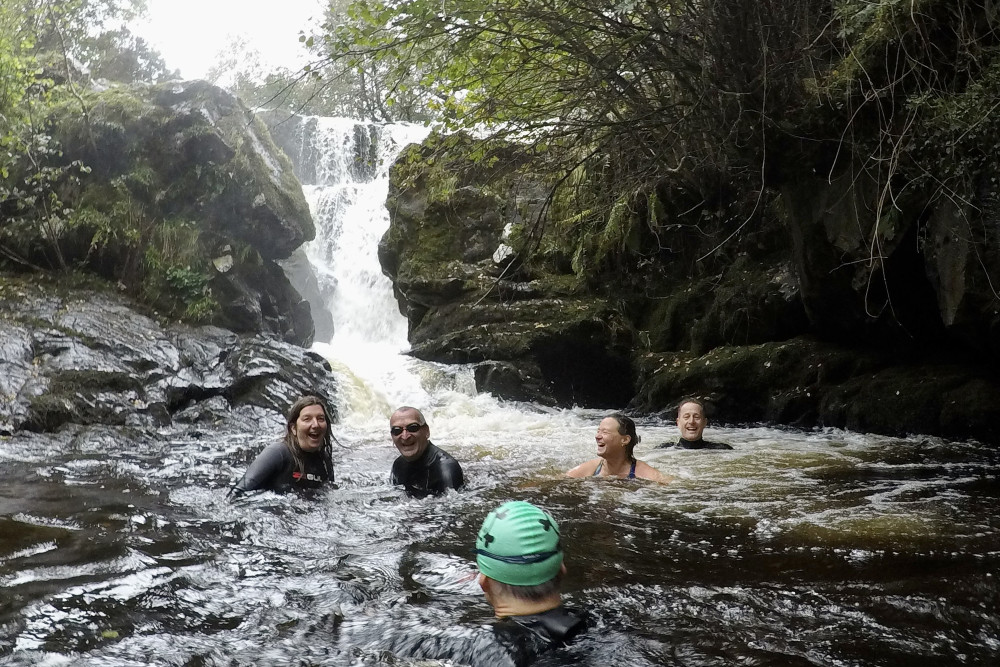 People swimming during the waterfall swim