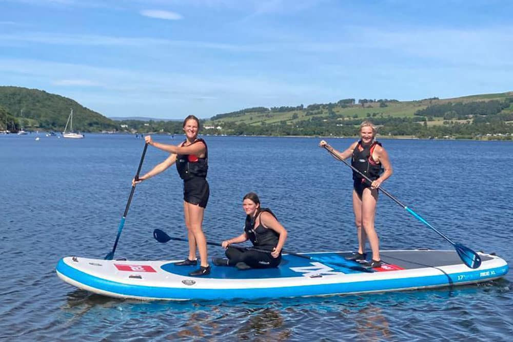 Jo Whiley and family stand up paddle boarding