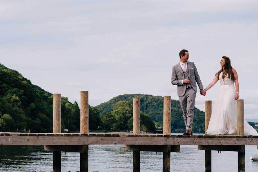 Bride and groom on the jetty at Another Place, The Lake