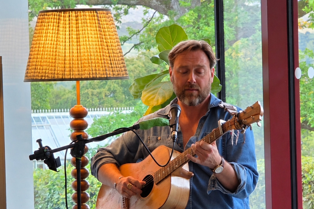 Liam Blake plays guitar in The Living Space