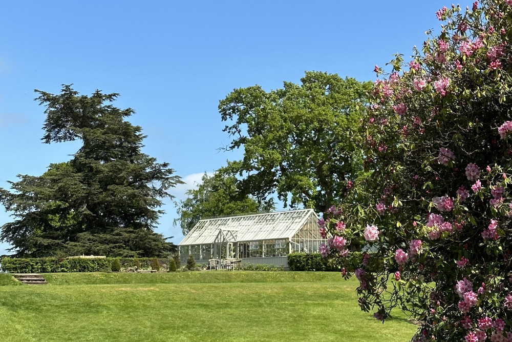 The Glasshouse and lawn at Another Place