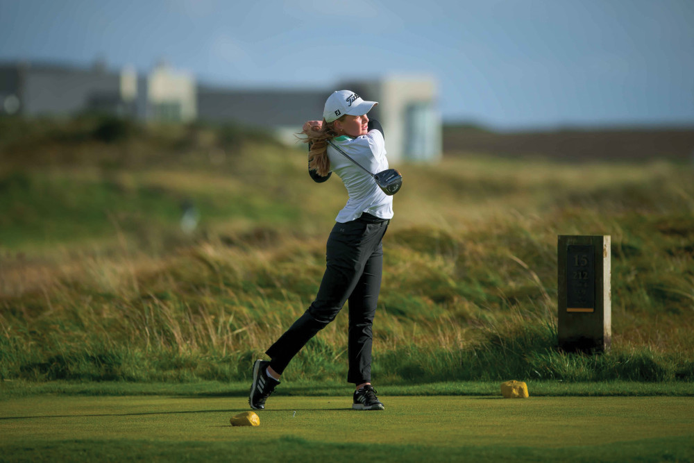 An image of a lady golfer in full swing, at The Machrie